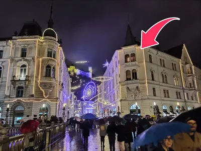 a group of people walking down a street at night at Filip’s Palace Luxurious Apartment in Ljubljana