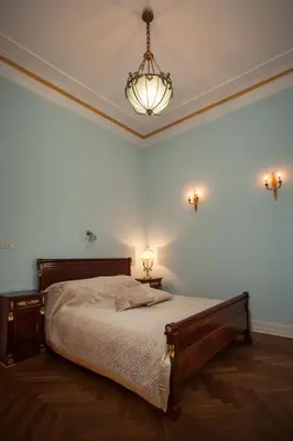 a bedroom with a bed and a chandelier at Filip’s Palace Luxurious Apartment in Ljubljana