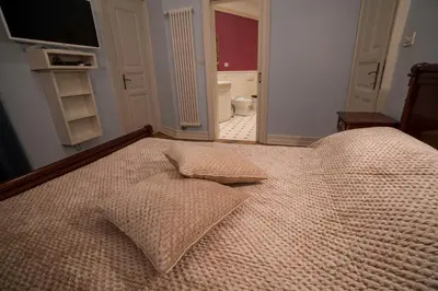 a large bed with a pillow on it in a bedroom at Filip’s Palace Luxurious Apartment in Ljubljana