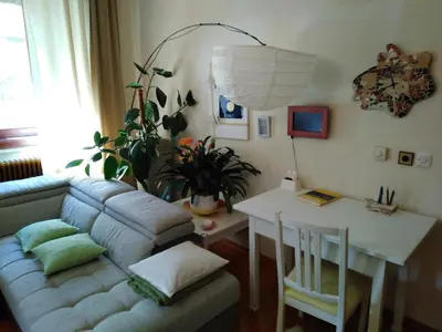 a living room with a couch and a table at Apartments Banko in Bled