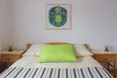 a bed with a green pillow on top of it at Apartments Banko in Bled