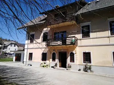 a large building with a balcony on a street at Apartments Banko in Bled