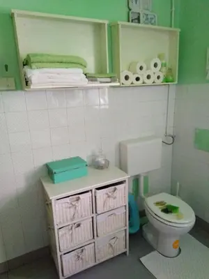 a small bathroom with a toilet and a sink at Apartments Banko in Bled