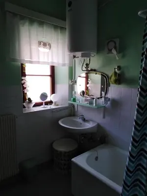 a bathroom with a sink and a mirror and a tub at Apartments Banko in Bled