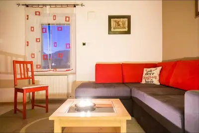 a living room with a couch and a table at Apartma Angelca in Kranjska Gora