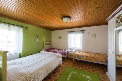 a bedroom with two beds and a wooden ceiling at Apartma Angelca in Kranjska Gora