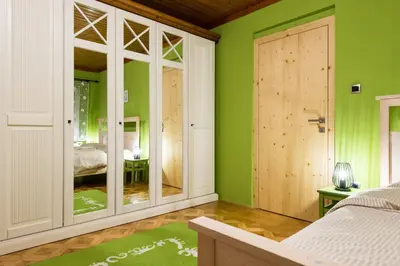 a bedroom with green walls and a bed at Apartma Angelca in Kranjska Gora