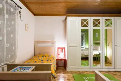 a childs bedroom with a bed and a table at Apartma Angelca in Kranjska Gora