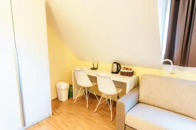 a small living room with a table and chairs at Dvorec Trebnik - SOBE in Slovenske Konjice