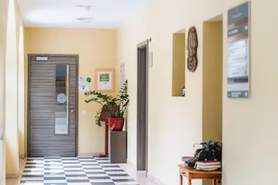 a hallway with a door and a potted plant at Dvorec Trebnik - SOBE in Slovenske Konjice
