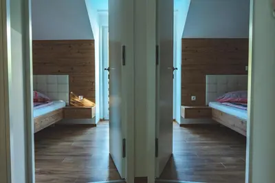 a hallway with two beds in a room at Hiša Katja-Privat wellness in Kranjska Gora
