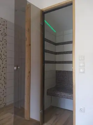 a shower with a glass door in a bathroom at Hiša Katja-Privat wellness in Kranjska Gora