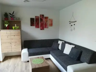a living room with a couch and a coffee table at Hiša Katja-Privat wellness in Kranjska Gora