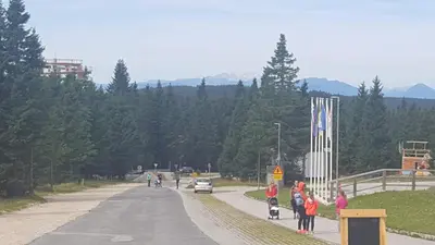 a group of children standing on the side of a road at Rogla app Jerebika 11 in Zreče