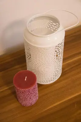 a candle and a cup on a table at Charming Apartments Ana in Maribor