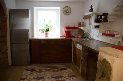 a kitchen with a stainless steel refrigerator and a window at Charming Apartments Ana in Maribor