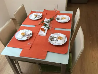 a table with red napkins and plates and glasses on it at Charming Apartments Ana in Maribor