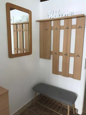 a mirror and a bench in a room at Charming Apartments Ana in Maribor