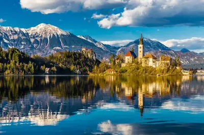 a castle on an island in the middle of a lake at Bled Paradise Apartments in Bled