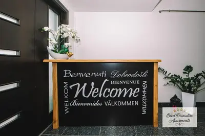 a chalkboard sign in a room with a welcome sign at Bled Paradise Apartments in Bled
