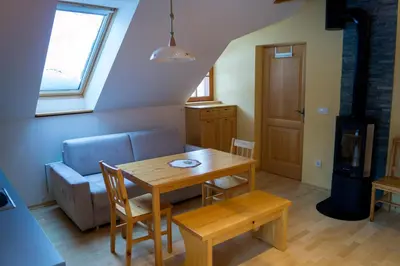 a living room with a table and a couch at Apartmaji Lajf in Kranjska Gora