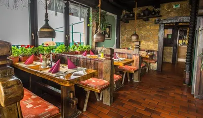 a restaurant with wooden tables and chairs with red napkins at Taverna & Wine Jeruzalem in Ivanjkovci