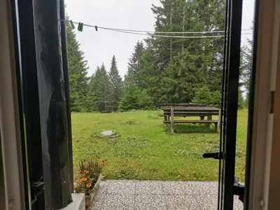 an open door to a yard with a picnic table at Apartma Gaber 80 in Zreče