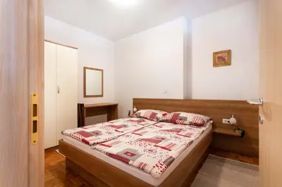 a small bedroom with a bed and a window at Apartma Luna in Kranjska Gora