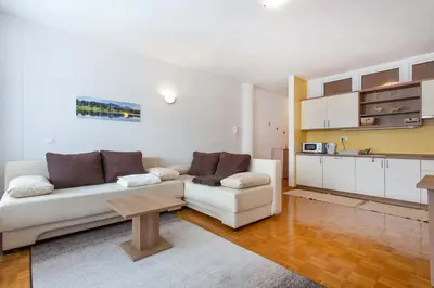 a living room with a white couch and a table at Apartma Luna in Kranjska Gora