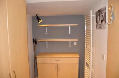 a room with two wooden shelves on a wall at Skier's cave in Kranjska Gora