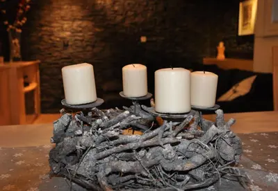 a group of candles sitting on top of a pile of sticks at Skier's cave in Kranjska Gora