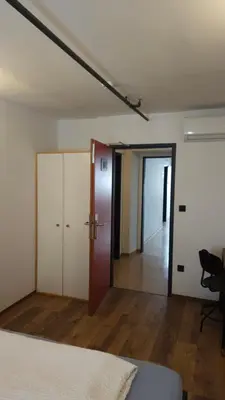 a bedroom with a bed and a door and a hallway at AdHoc Hostel in Ljubljana