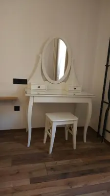 a white dressing table with a mirror and a stool at AdHoc Hostel in Ljubljana
