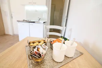 a tray of food on a table with two cups at Hotel Katrca in Ljubljana