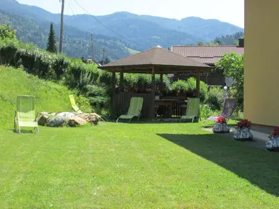 a gazebo with chairs and a table in a yard at TURISTIČNA KMETIJA LIPNIK in Lovrenc na Pohorju