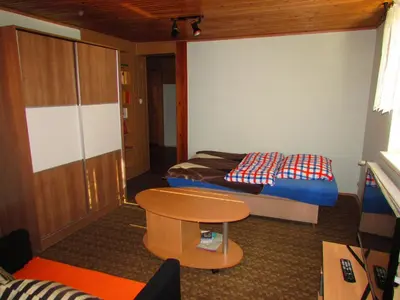 a small room with a bed and a table at TURISTIČNA KMETIJA LIPNIK in Lovrenc na Pohorju