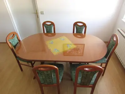 a wooden table with four chairs around it at TURISTIČNA KMETIJA LIPNIK in Lovrenc na Pohorju