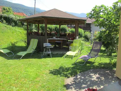 a group of chairs in a yard with a gazebo at TURISTIČNA KMETIJA LIPNIK in Lovrenc na Pohorju