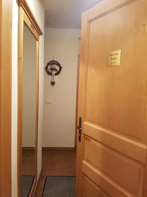 a door with a sign on it next to a hallway at Apartma Lenka Kranjska Gora in Kranjska Gora