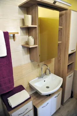 a bathroom with a sink and a mirror at apartma Marjetica in Blejska Dobrava