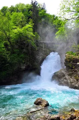 a waterfall in the middle of a river at apartma Marjetica in Blejska Dobrava