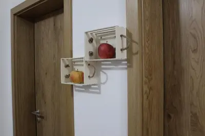 an oven with two apples in it next to a door at Vdovič Guest House in Svečina