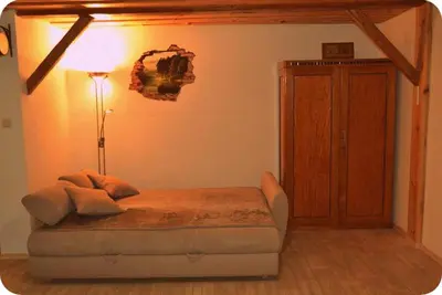 a bedroom with a bed and a lamp and a cabinet at Apartma & savna Slapnik in Luče