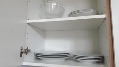 a kitchen with white plates and a sink at Metelkova in Ljubljana