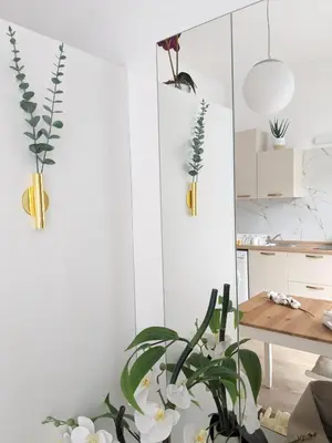 a kitchen with white walls and a table with plants at Metelkova in Ljubljana