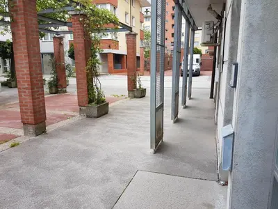 an empty hallway of a building with columns at Metelkova in Ljubljana
