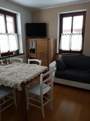 a living room with a table and a couch at Nigritella in Kranjska Gora