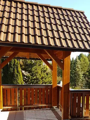 a wooden pavilion with a roof on a deck at Nigritella in Kranjska Gora