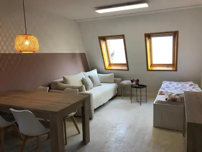 a living room with a couch and a table at Bovec Apartment in Bovec