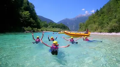 a group of people in the water on a river at Bovec Apartment in Bovec